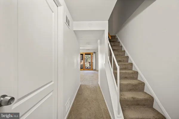 a view of a hallway with wooden floor and entryway
