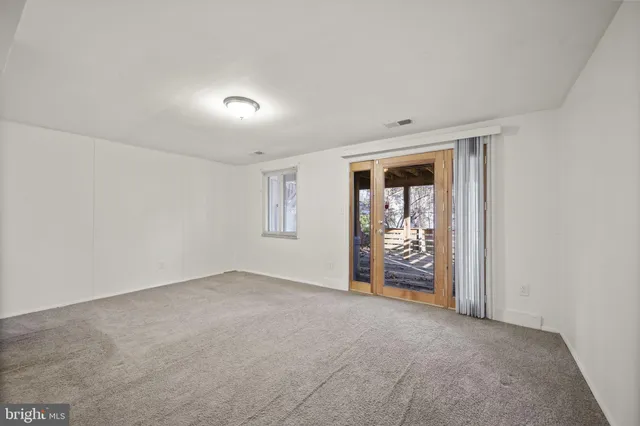 an empty room with closet and a window