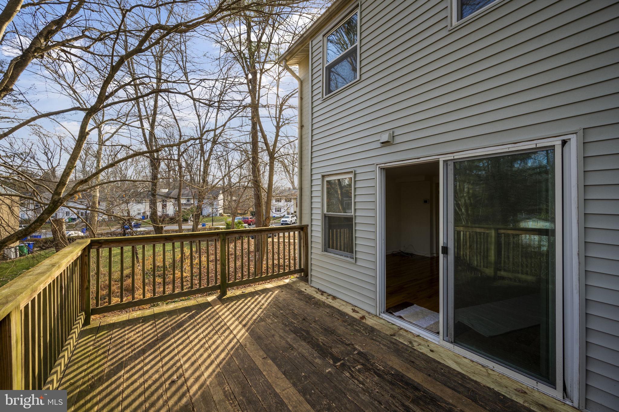 5451 Endicott Lane Columbia, MD 21044 - Photo 26 of 28 a view of a balcony with wooden floor and fence and a window