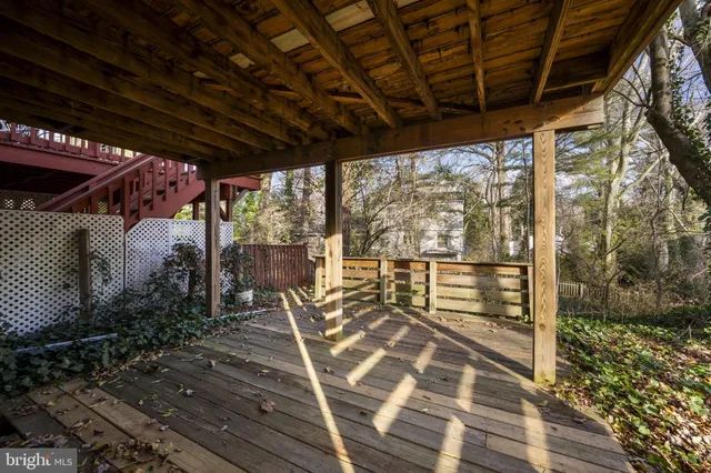 a view of a house with a stairs and wooden fence