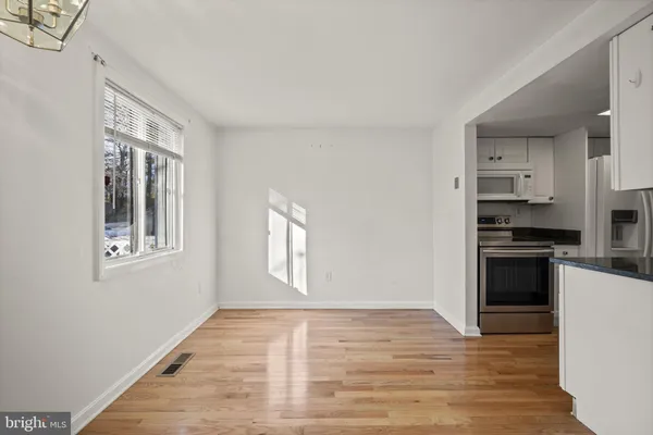 a view of a kitchen from the hallway