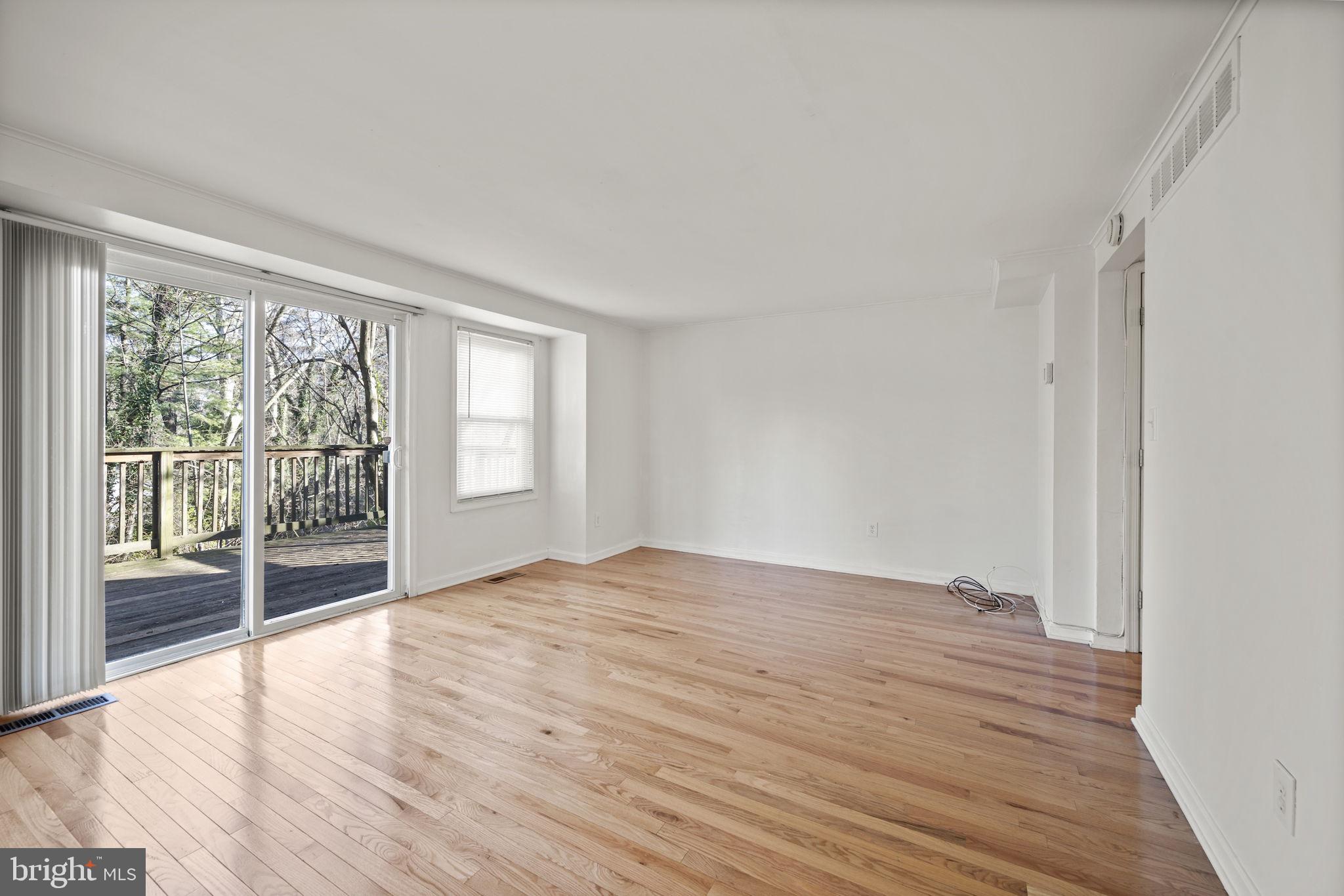 5451 Endicott Lane Columbia, MD 21044 - Photo 7 of 28 a view of an empty room with wooden floor and a window