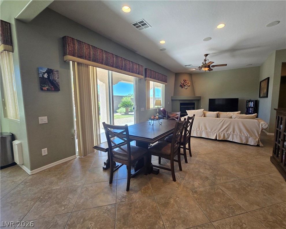 2567 Dirleton Place Henderson, NV 89044 - Photo 20 of 67 An inviting open-concept living space features a cozy corner fireplace and seamless outdoor access.