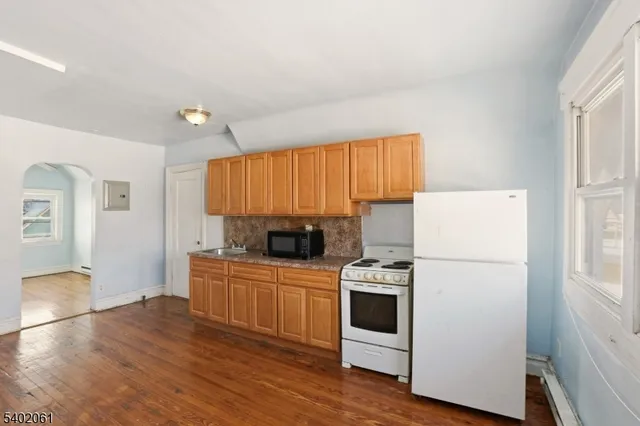 a bathroom with a granite countertop toilet a sink and bathtub
