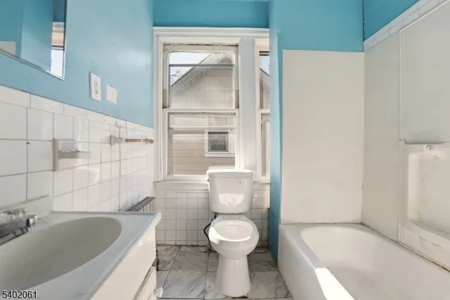 a view of a hallway with wooden floor and entryway