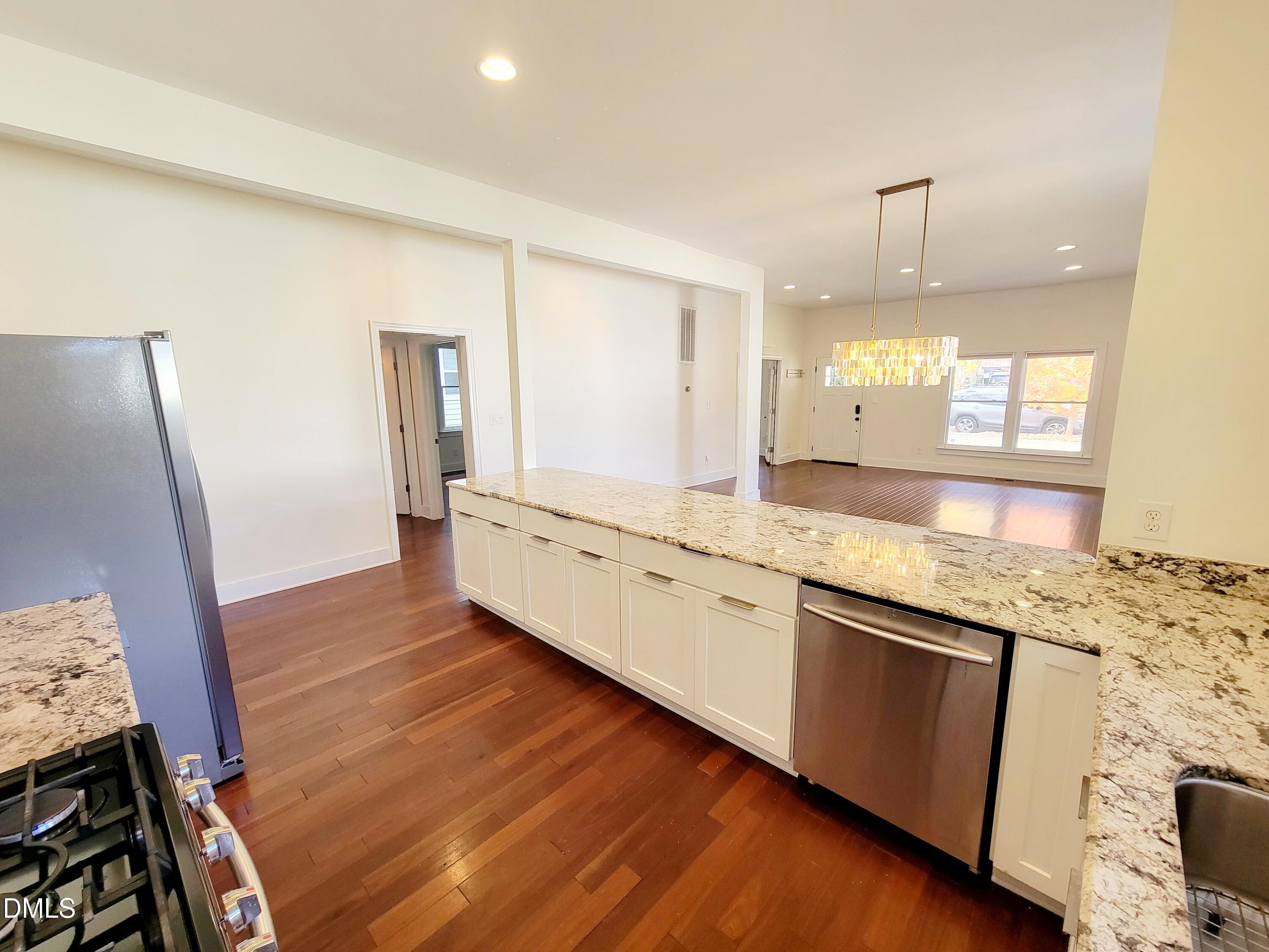 707 South East Street Raleigh, NC 27601 - Photo 12 of 46 a large bathroom with a granite countertop sink and a mirror