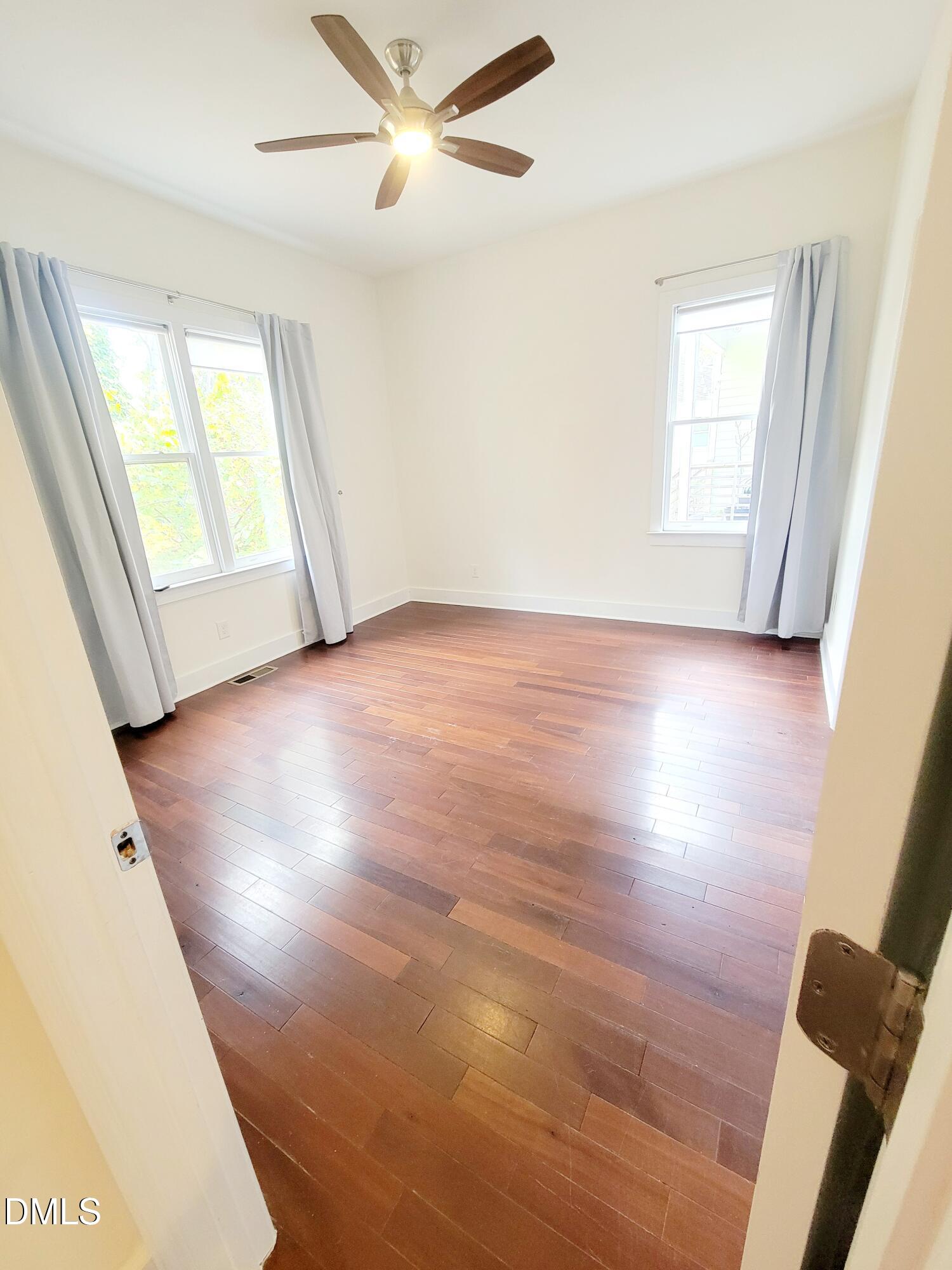 707 South East Street Raleigh, NC 27601 - Photo 13 of 46 a view of an empty room with wooden floor and a window