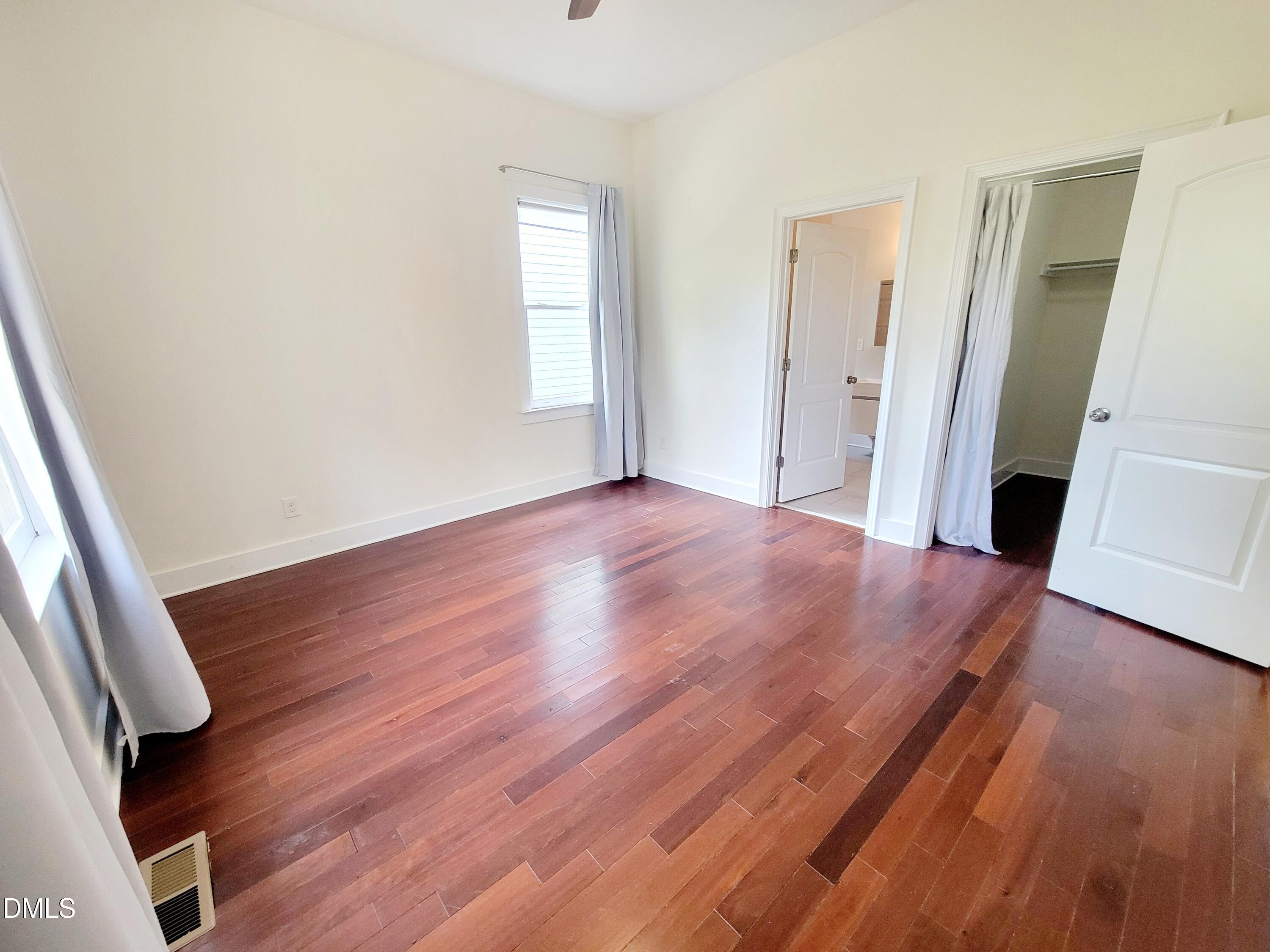 707 South East Street Raleigh, NC 27601 - Photo 15 of 46 wooden floor in an empty room with a window
