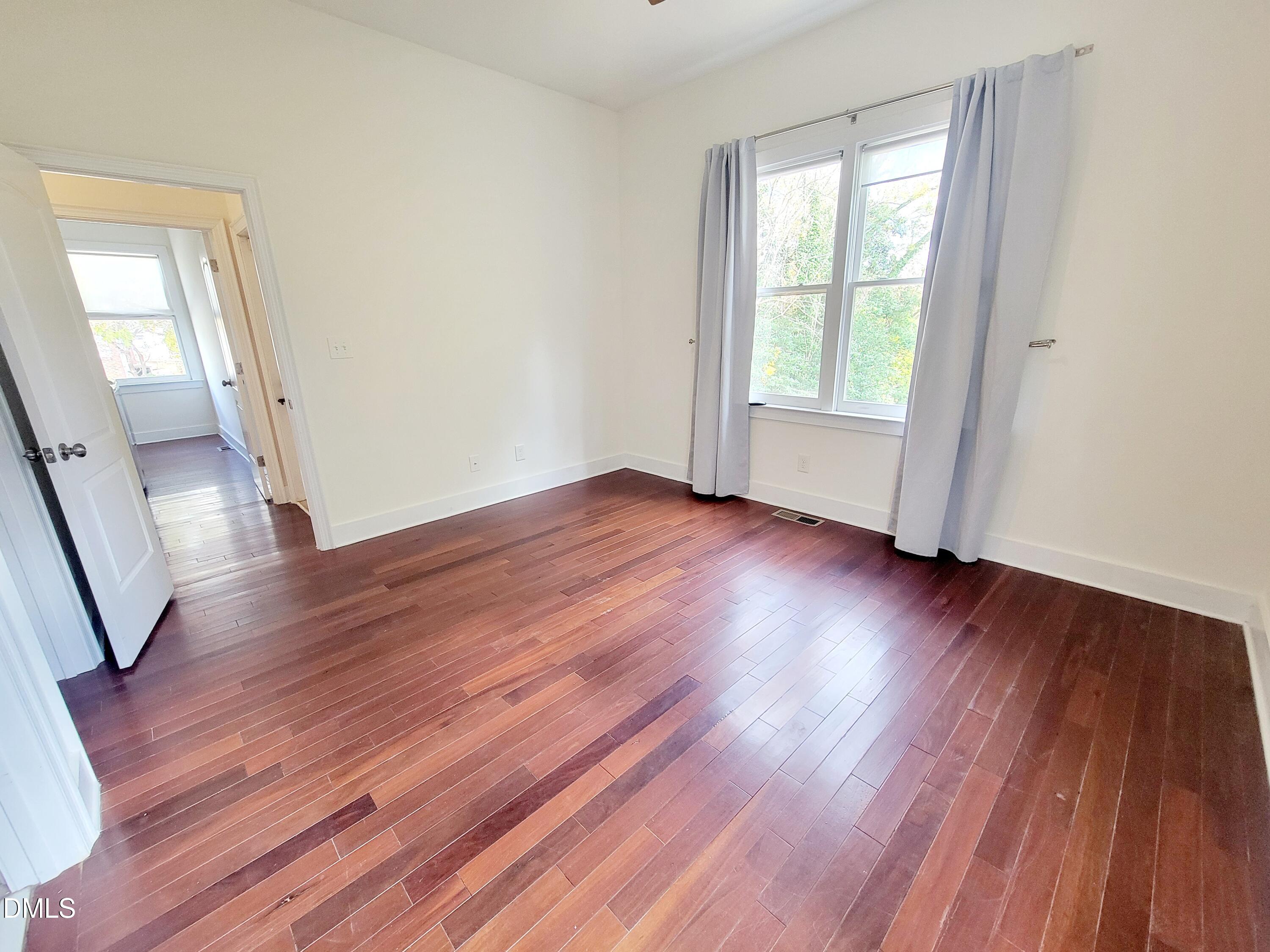 707 South East Street Raleigh, NC 27601 - Photo 17 of 46 a view of an empty room with wooden floor and a window