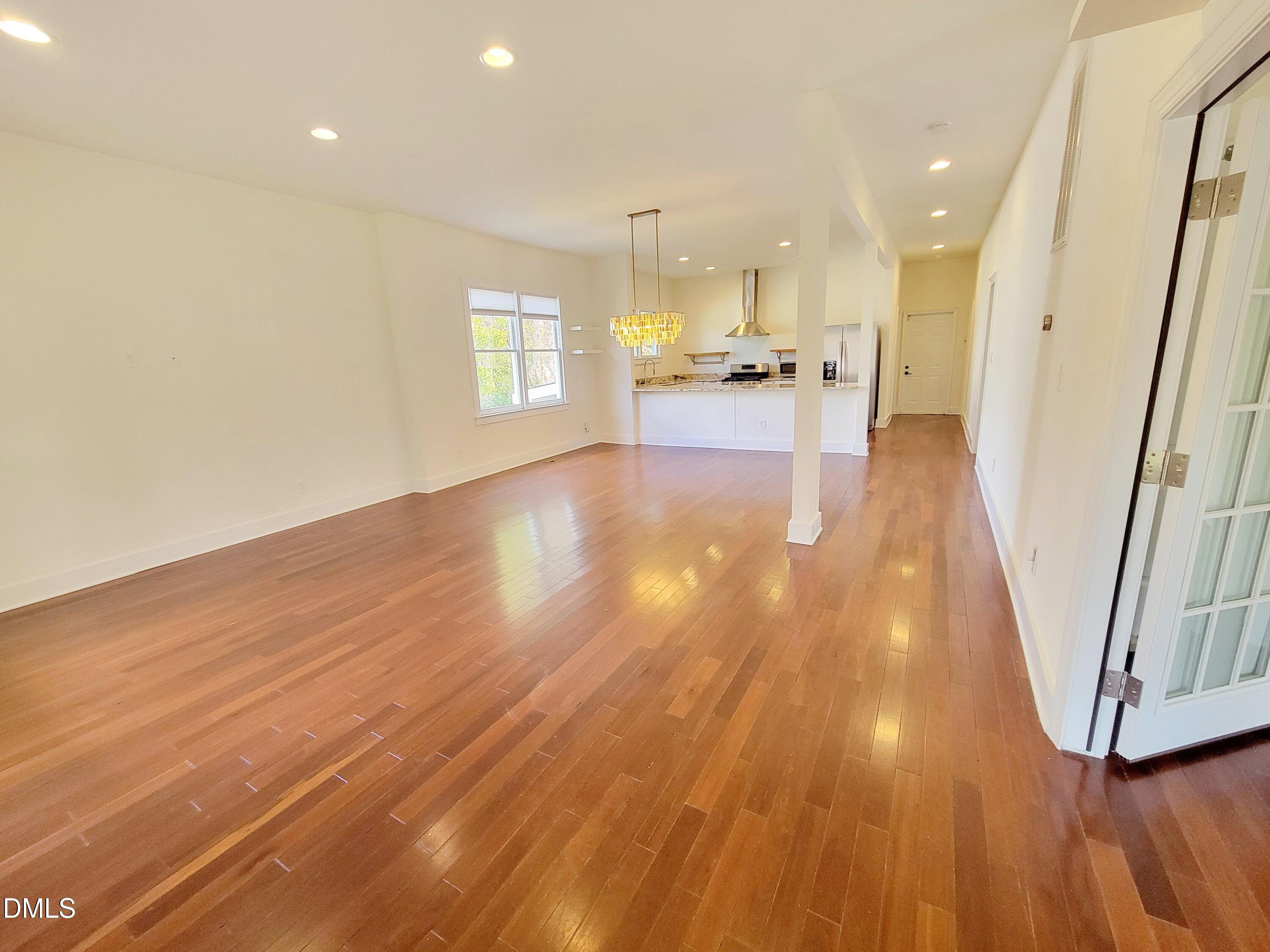 707 South East Street Raleigh, NC 27601 - Photo 2 of 46 a view of a living room with wooden floor and a large window