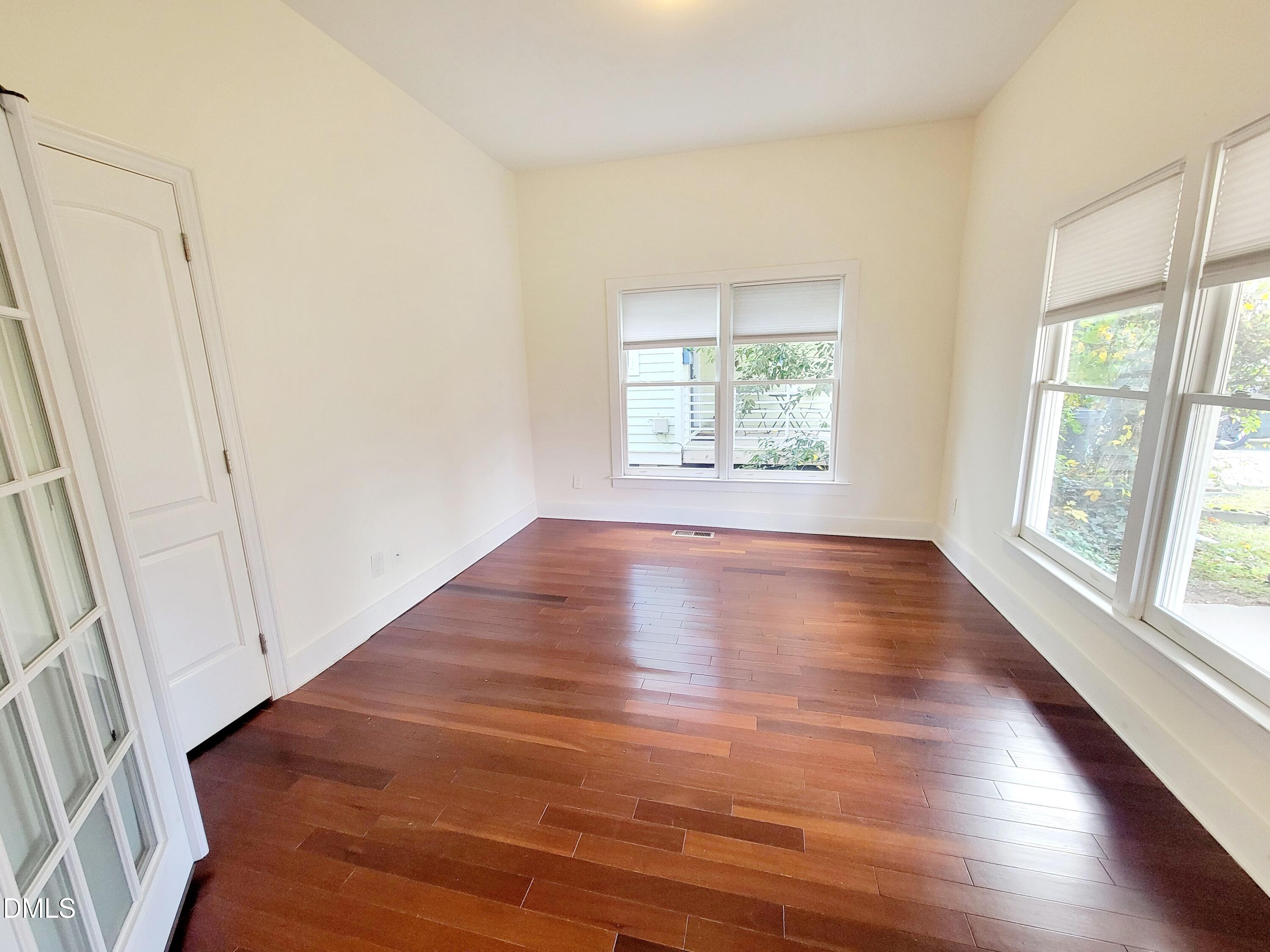 707 South East Street Raleigh, NC 27601 - Photo 24 of 46 an empty room with wooden floor and windows