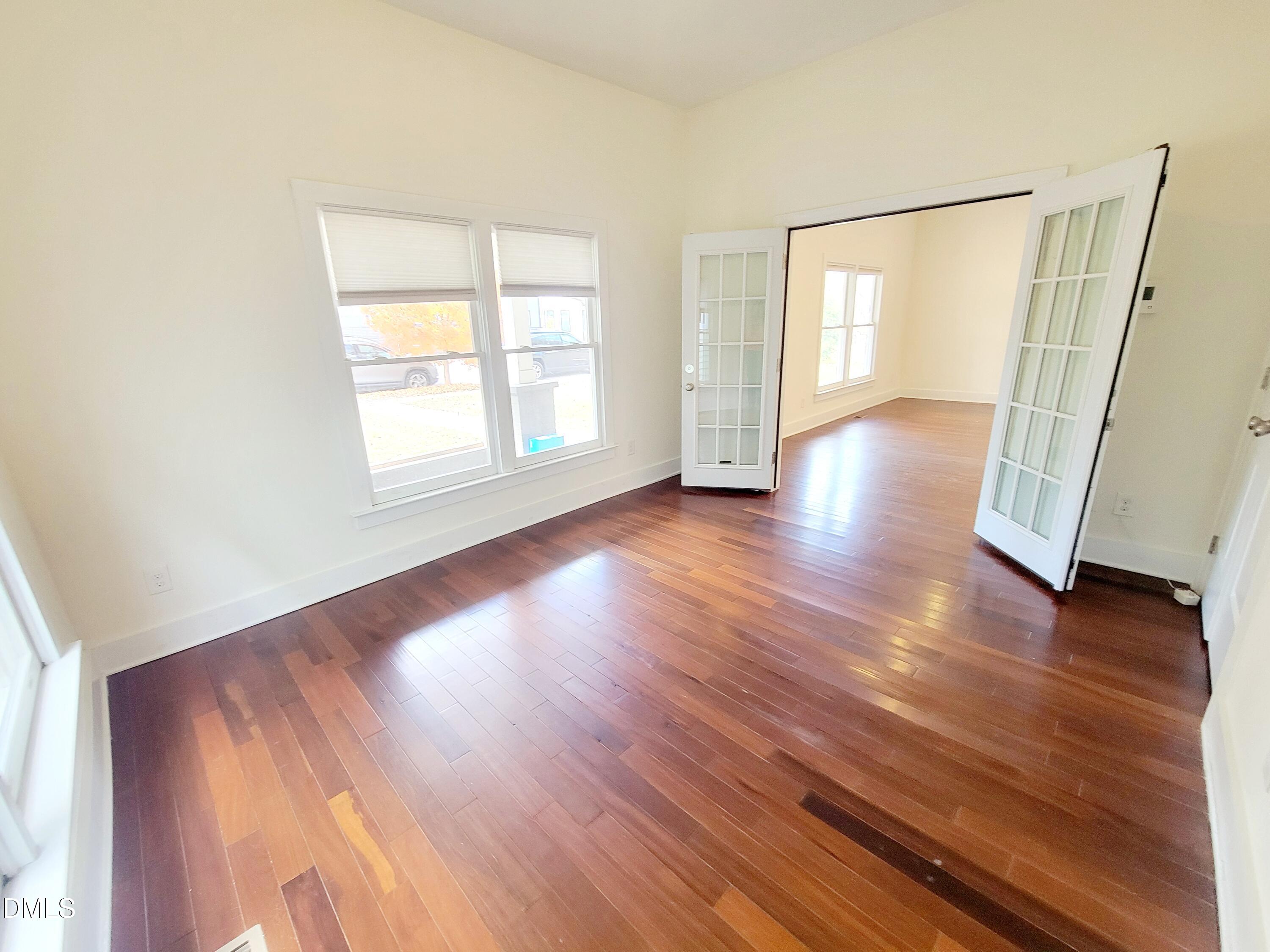707 South East Street Raleigh, NC 27601 - Photo 26 of 46 an empty room with wooden floor and windows