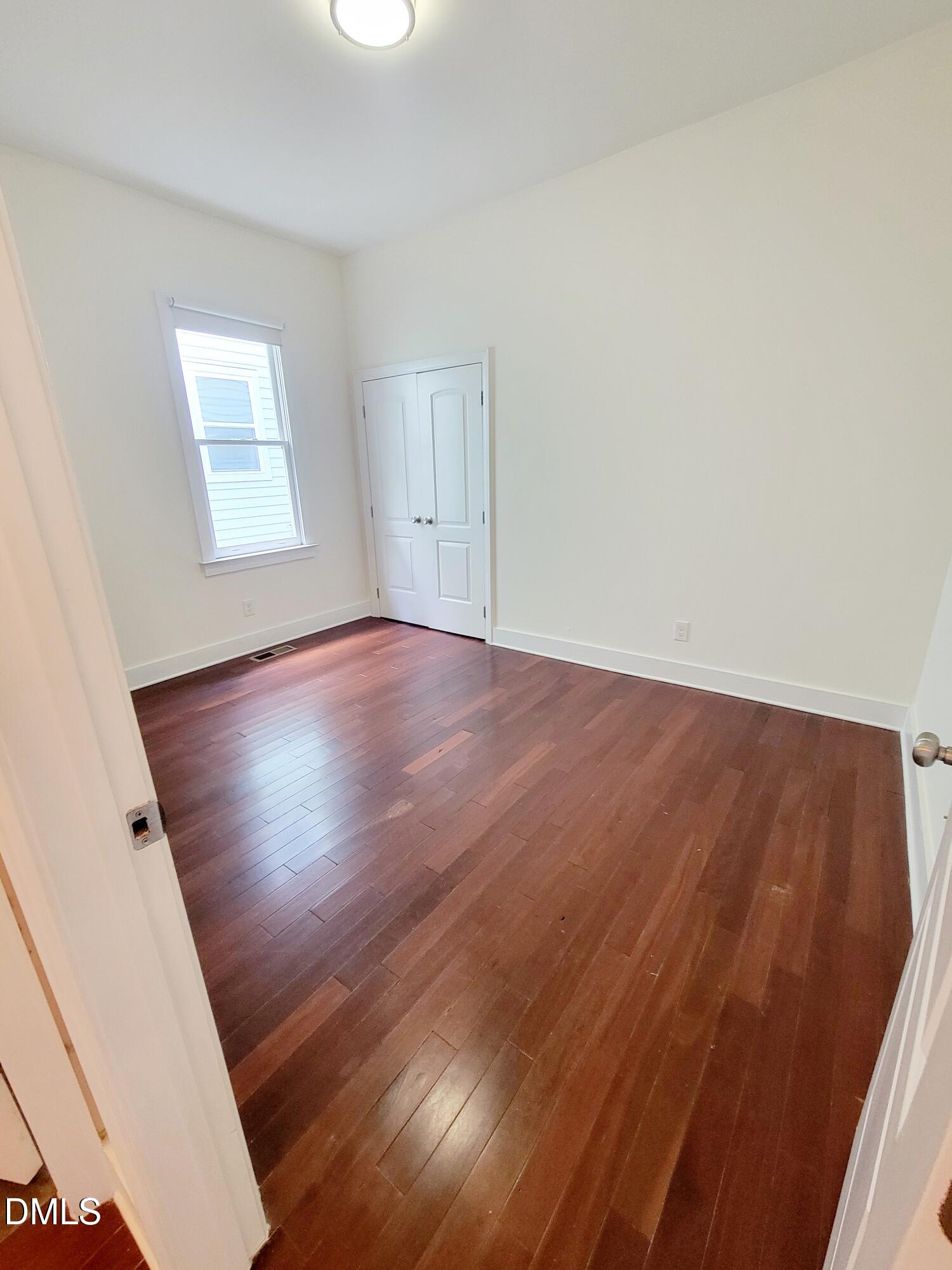 707 South East Street Raleigh, NC 27601 - Photo 28 of 46 an empty room with wooden floor and windows