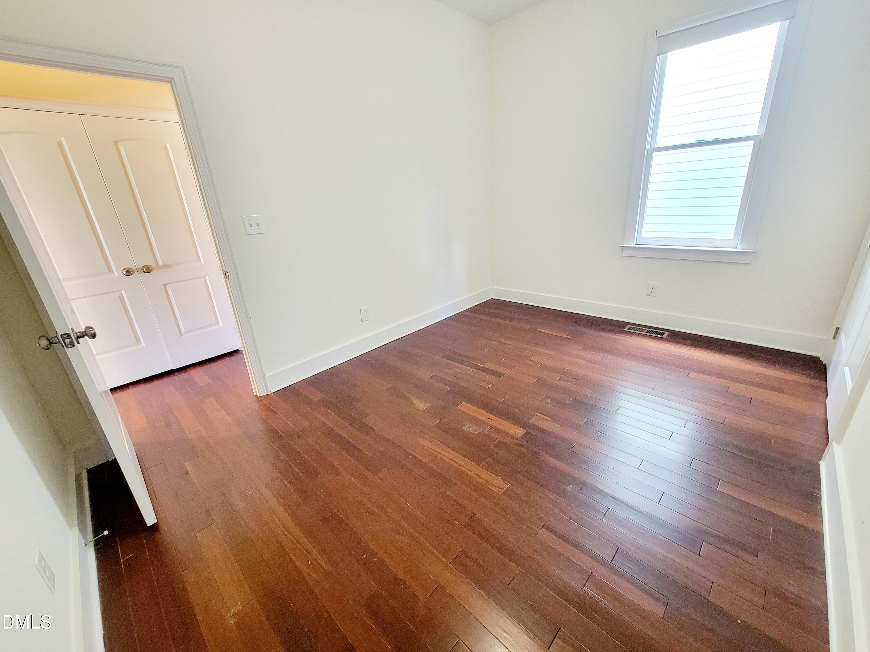 707 South East Street Raleigh, NC 27601 - Photo 30 of 46 an empty room with wooden floor and windows