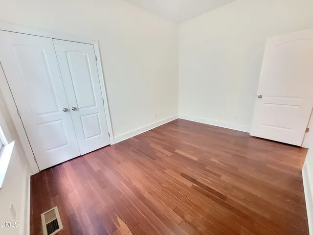 a view of a room with wooden floor