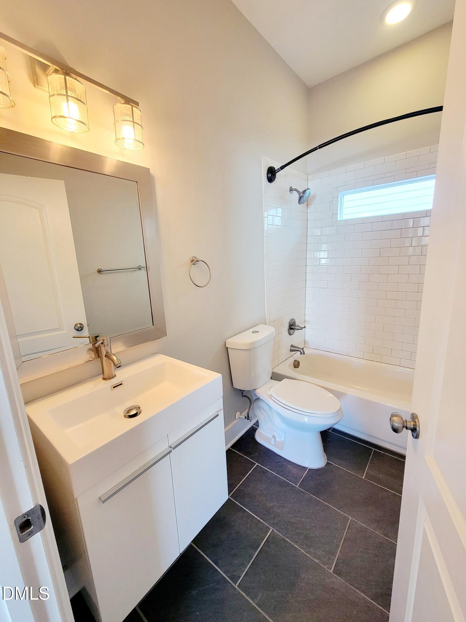 707 South East Street Raleigh, NC 27601 - Photo 34 of 46 a bathroom with a sink and a mirror