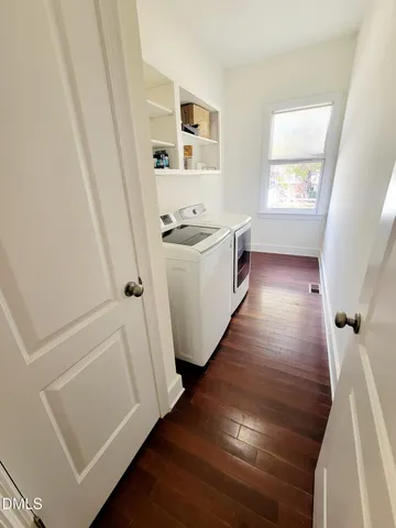 a view of utility room with wooden floor and window