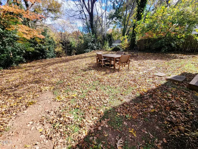 a backyard of a house with table and chairs