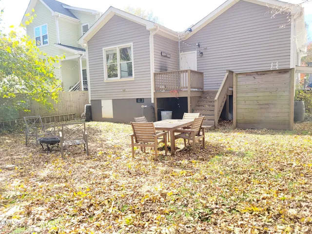 a backyard of a house with table and chairs