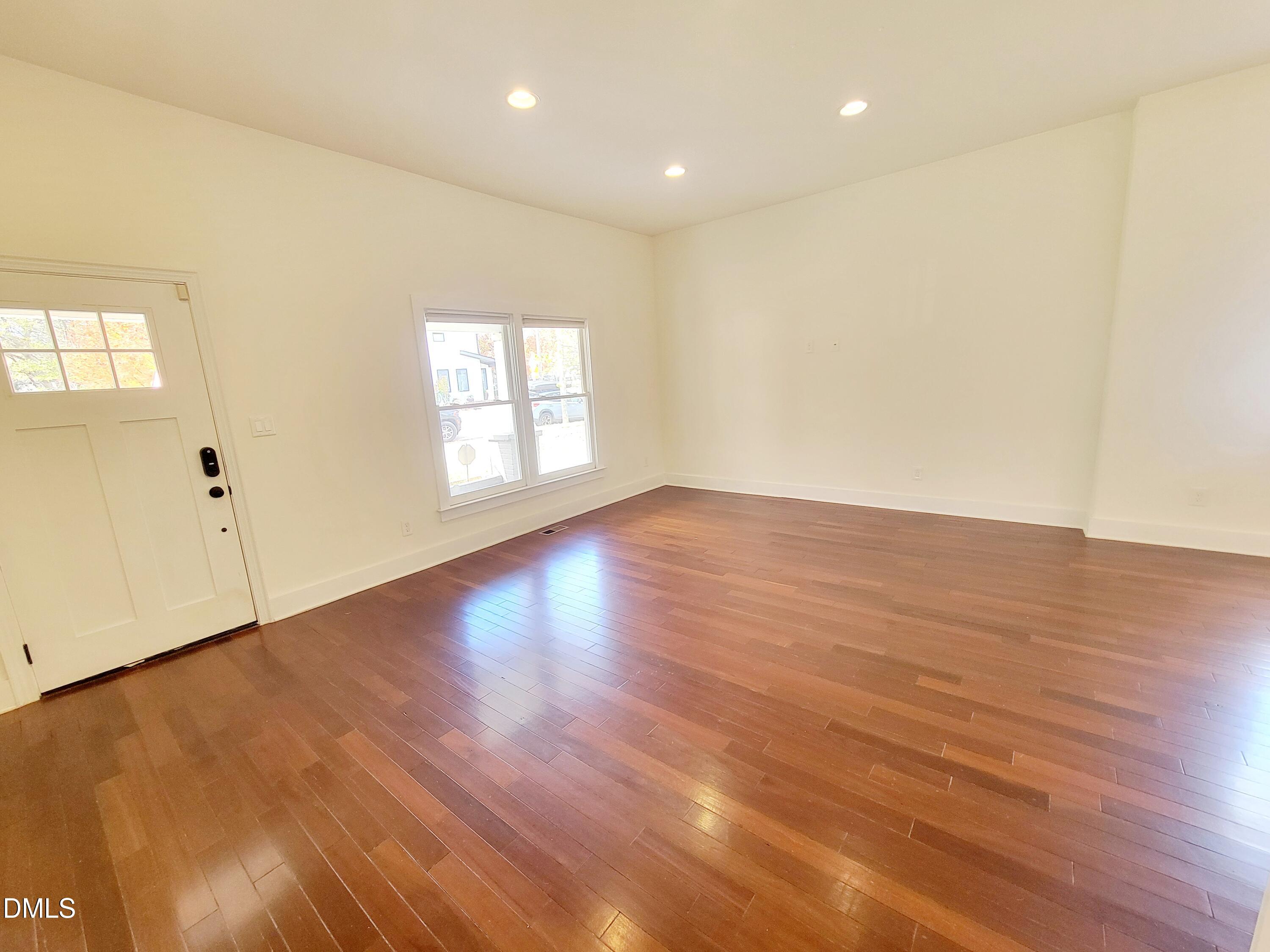 707 South East Street Raleigh, NC 27601 - Photo 6 of 46 an empty room with wooden floor and windows