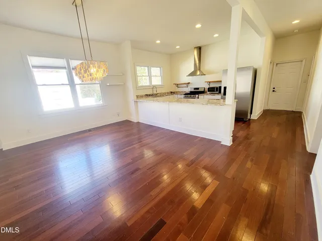 a view of kitchen with cabinets and wooden floor