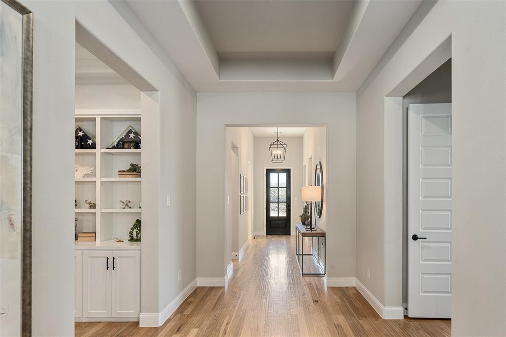 15308 Sassafras Road Frisco, TX 75035 - Photo 10 of 32 Stunning entry with high ceilings and wood floors throughout. Media room is carpeted.