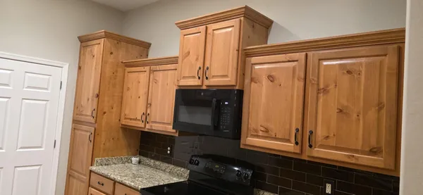 a kitchen with granite countertop a sink and cabinets