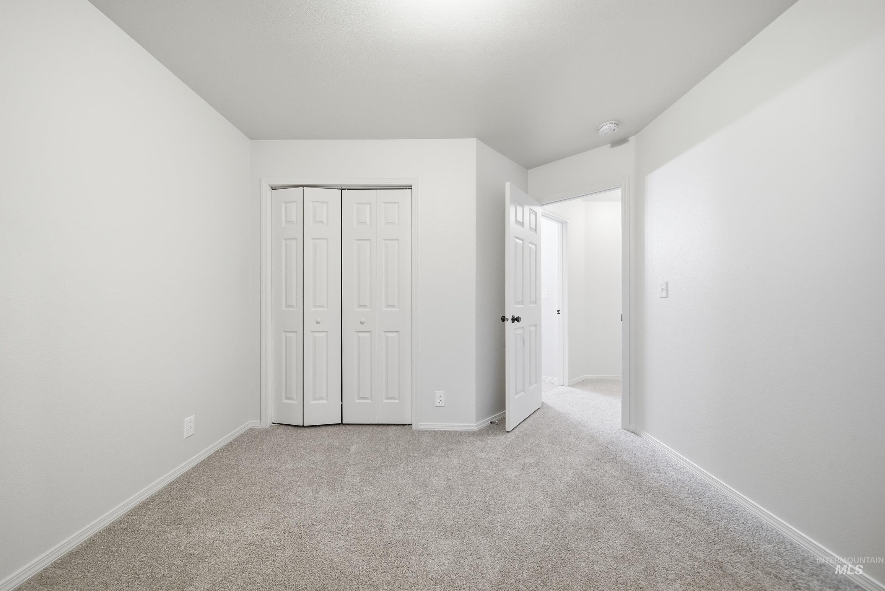 919 East Hawk Street Meridian, ID 83646 - Photo 17 of 31 Light gray carpeting, white walls, and a bi-fold closet door
