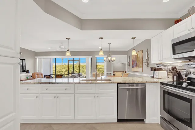 a kitchen with stainless steel appliances granite countertop a stove and cabinets