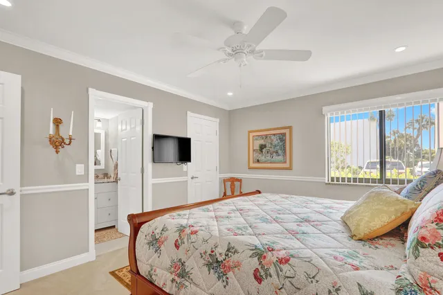 a bedroom with a large bed and a tv