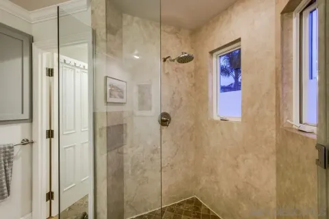 a bedroom with a large bed and a large window