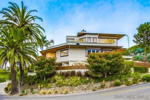 a view of a house with a flower garden
