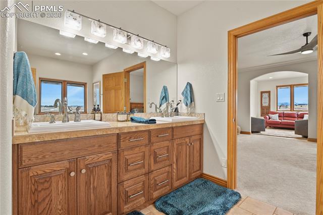 5220 Roundup Ridge Road Colorado Springs, CO 80908 - Photo 17 of 50 Primary suite bathroom with double sinks, new lighting