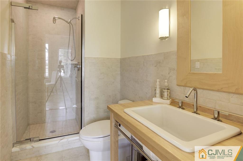 105 Elm Road Princeton, NJ 08540 - Photo 18 of 25 a bathroom with a sink toilet and shower
