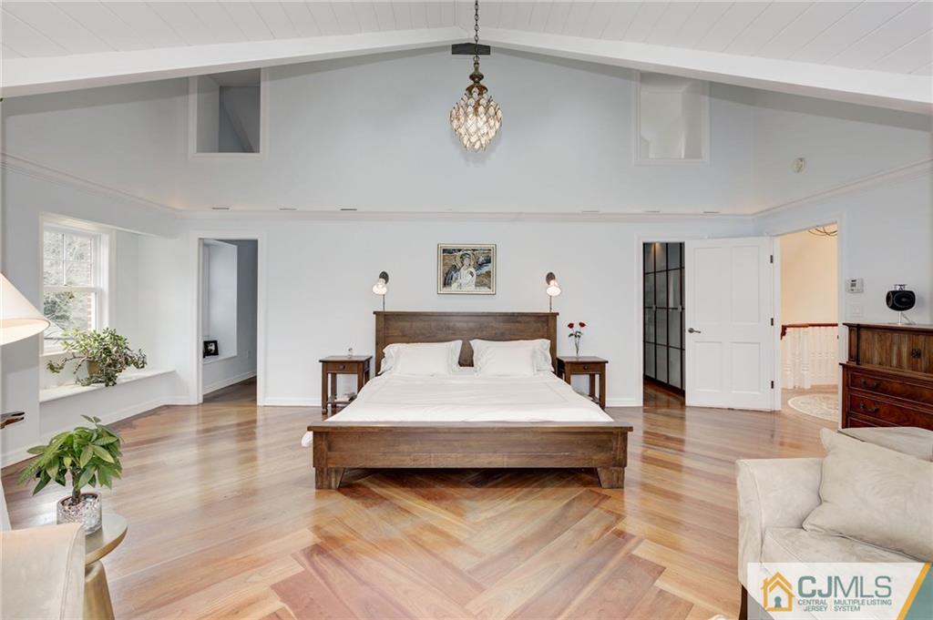 105 Elm Road Princeton, NJ 08540 - Photo 19 of 25 a bedroom with a bed chandelier and a window