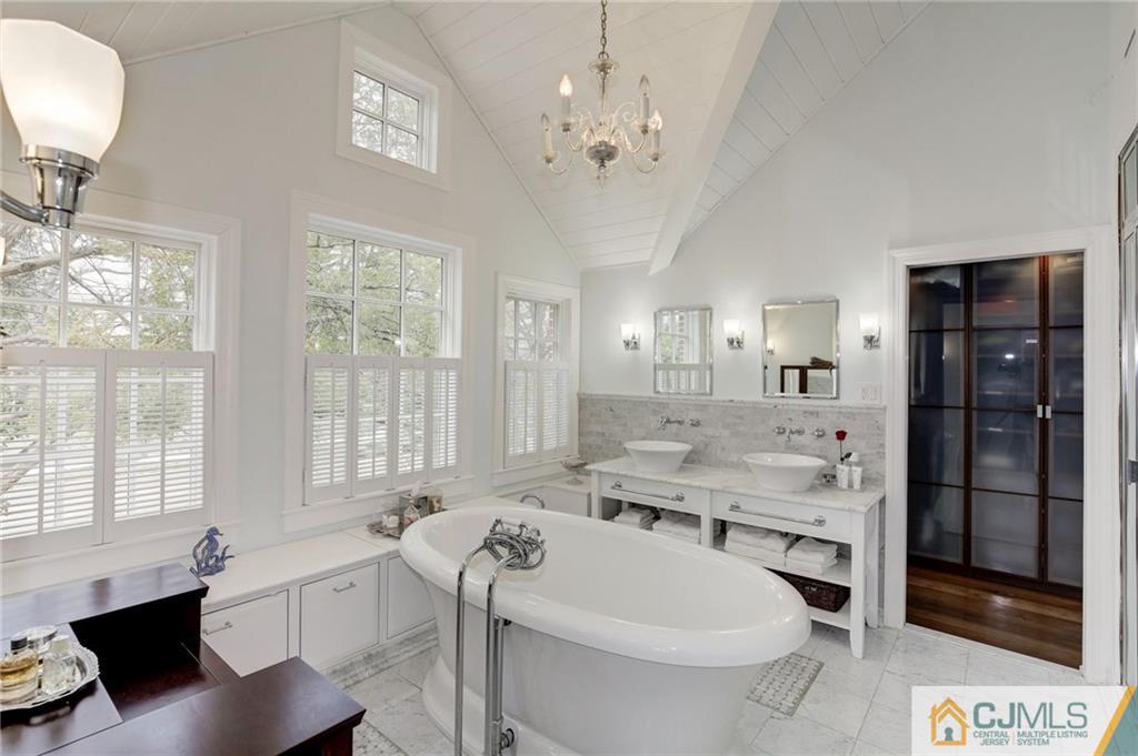 105 Elm Road Princeton, NJ 08540 - Photo 21 of 25 a spacious bathroom with a tub sink and mirror