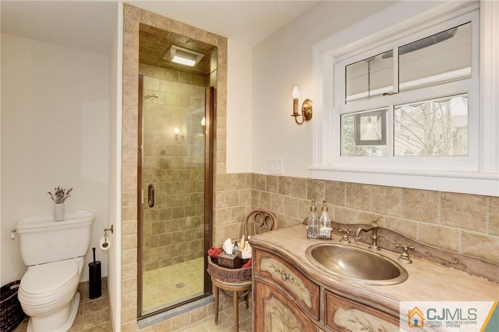 105 Elm Road Princeton, NJ 08540 - Photo 8 of 25 a bathroom with a toilet sink shower and mirror