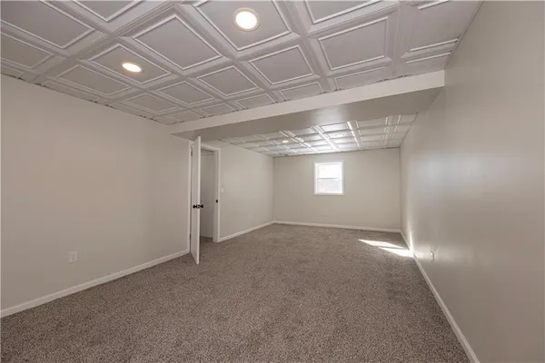 a kitchen with stainless steel appliances granite countertop a refrigerator a sink dishwasher a stove and white countertops with wooden floor