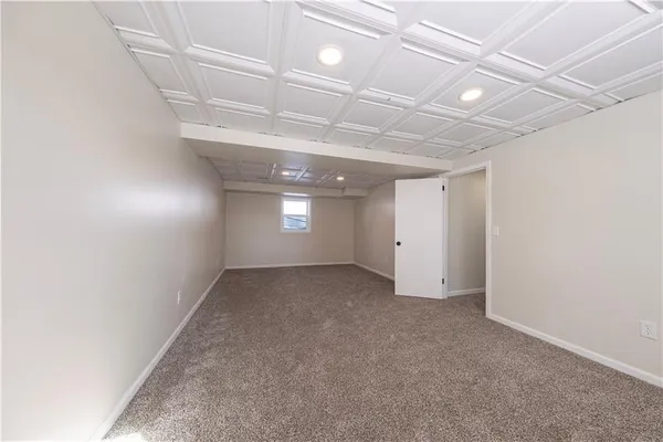a kitchen with a refrigerator and a stove top oven
