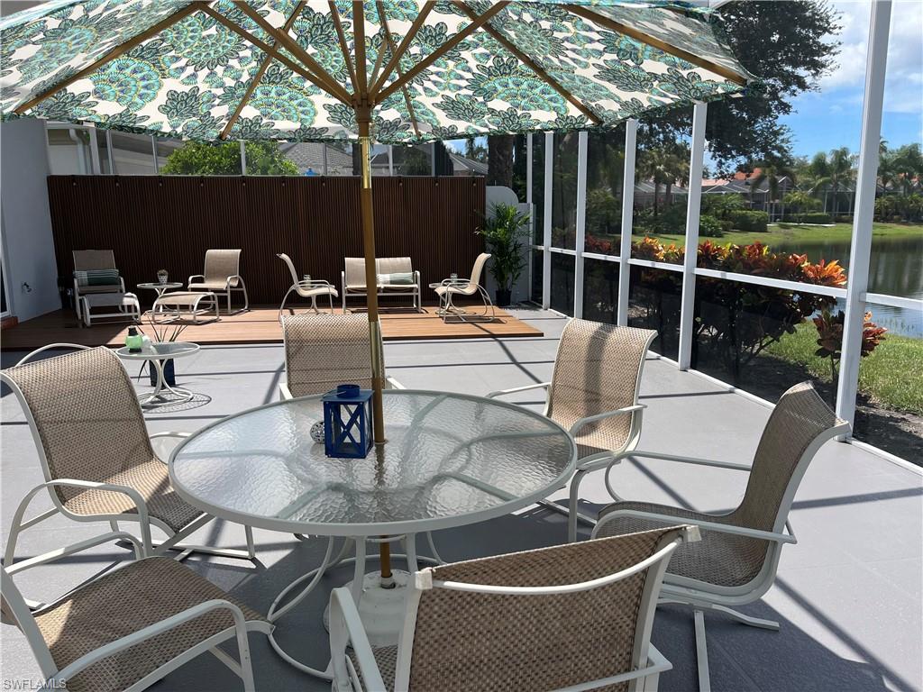 5477 Freeport Lane Naples, FL 34119 - Photo 23 of 36 a view of a patio with couches table and chairs
