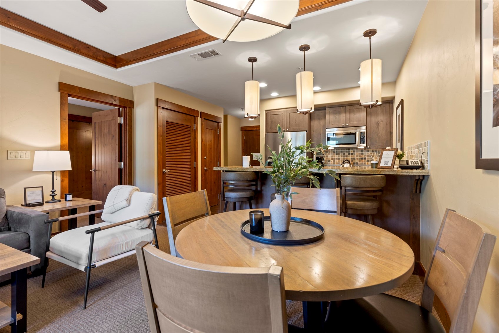 1521 Ski Hill Road, Unit 8313 Breckenridge, CO 80424 - Photo 17 of 45 a dining room with glass table and chairs