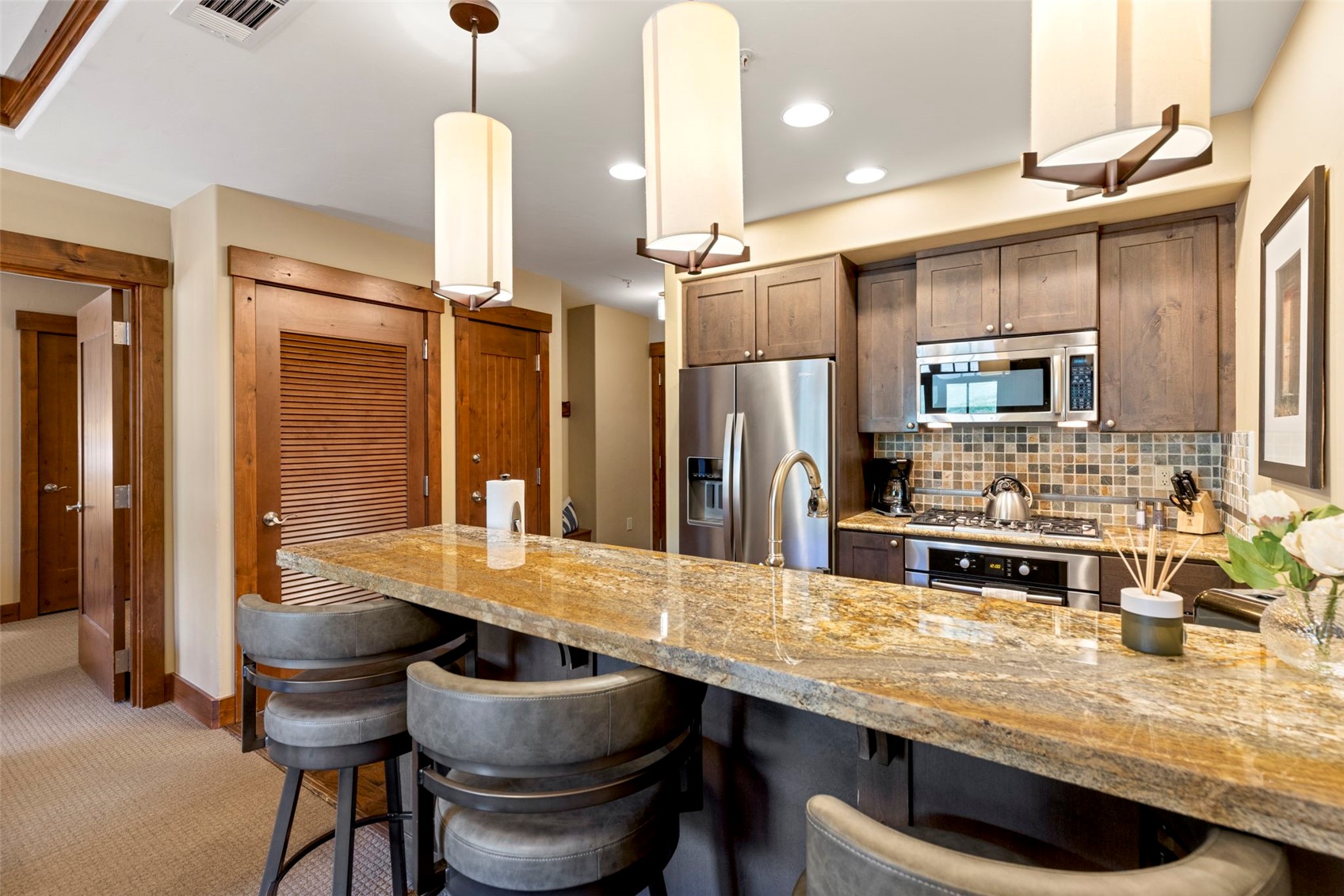 1521 Ski Hill Road, Unit 8313 Breckenridge, CO 80424 - Photo 19 of 45 a kitchen with a table and chairs