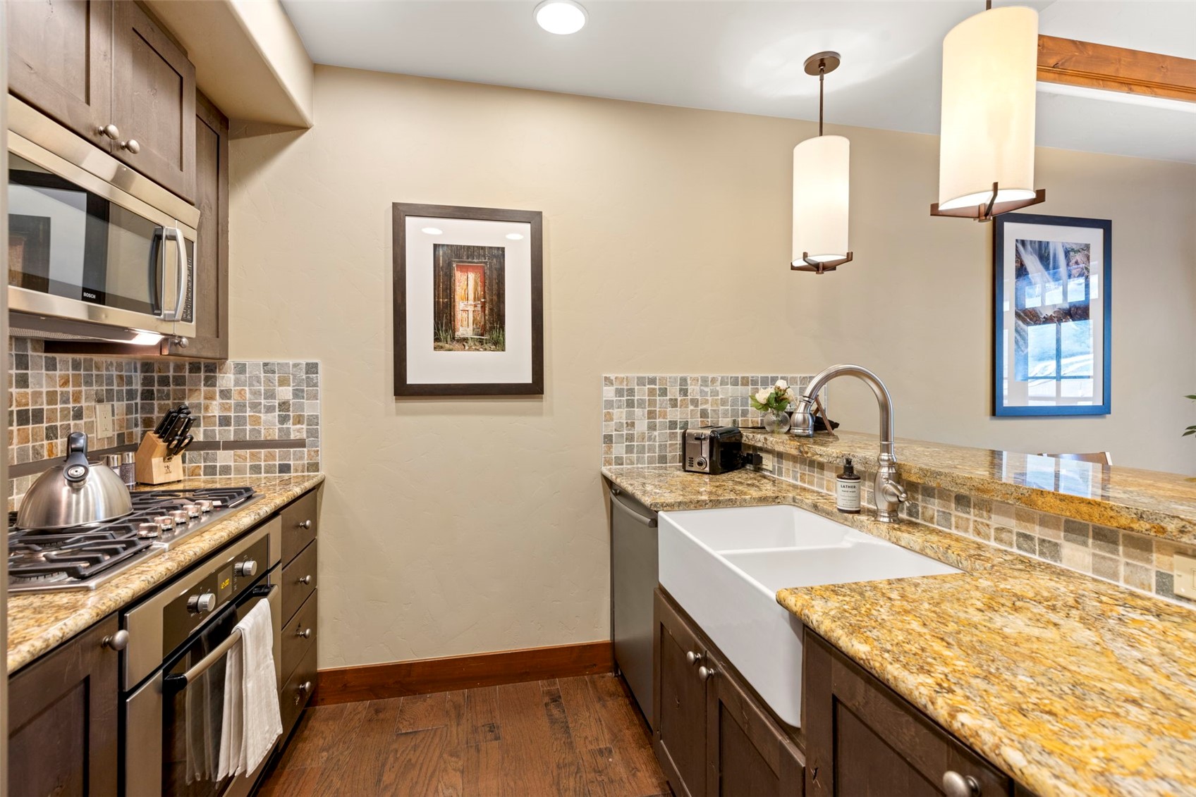 1521 Ski Hill Road, Unit 8313 Breckenridge, CO 80424 - Photo 21 of 45 a kitchen with stainless steel appliances granite countertop a sink stove and cabinets