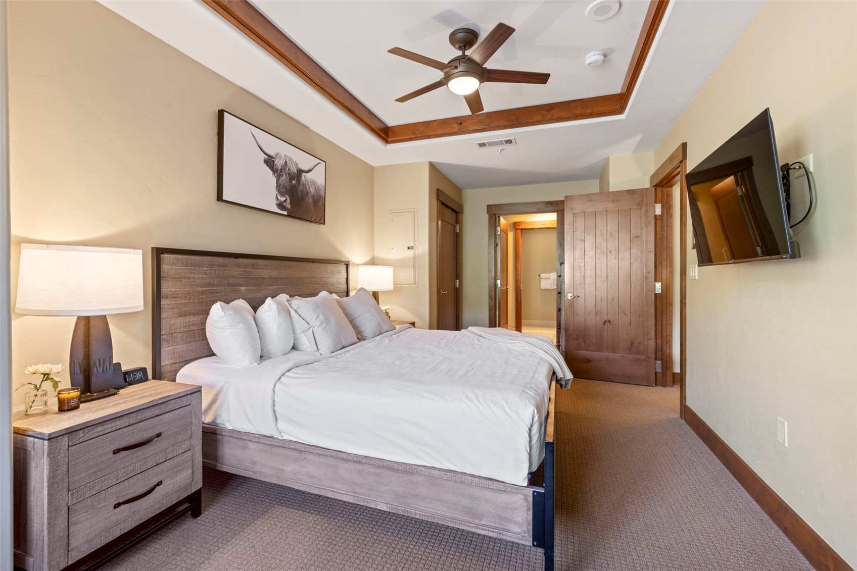 1521 Ski Hill Road, Unit 8313 Breckenridge, CO 80424 - Photo 25 of 45 a bedroom with a bed and a flat screen tv