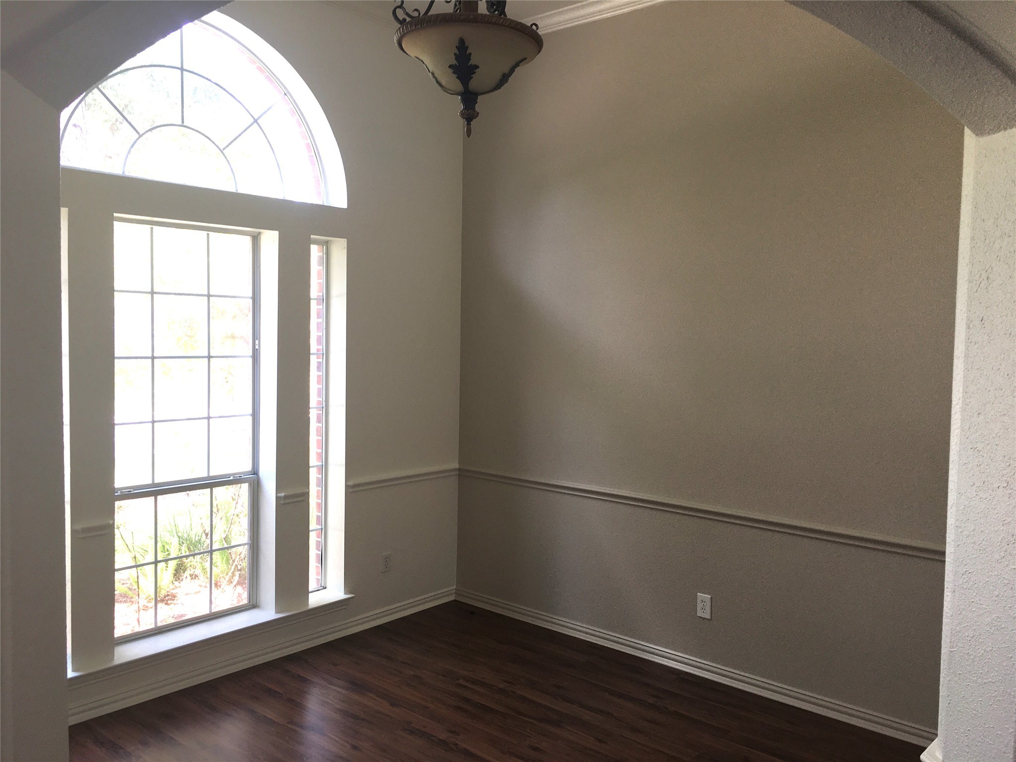 10730 Sea Myrtle Drive Houston, TX 77095 - Photo 12 of 36 an empty room with wooden floor chandelier and windows