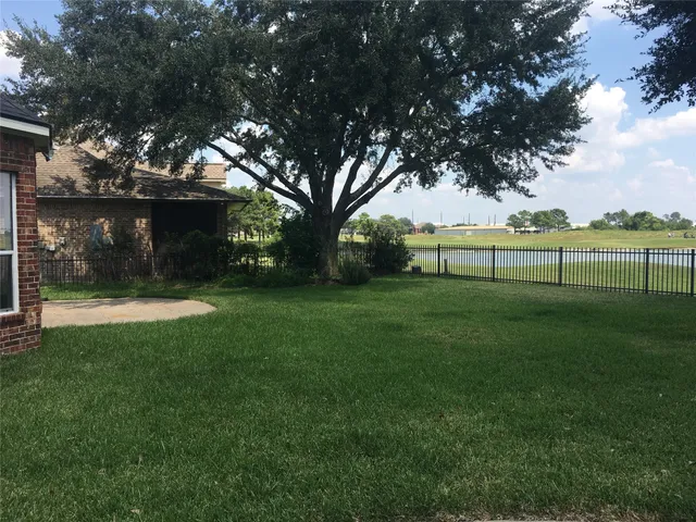 a kitchen with granite countertop a sink dishwasher a stove and a microwave oven with wooden floor