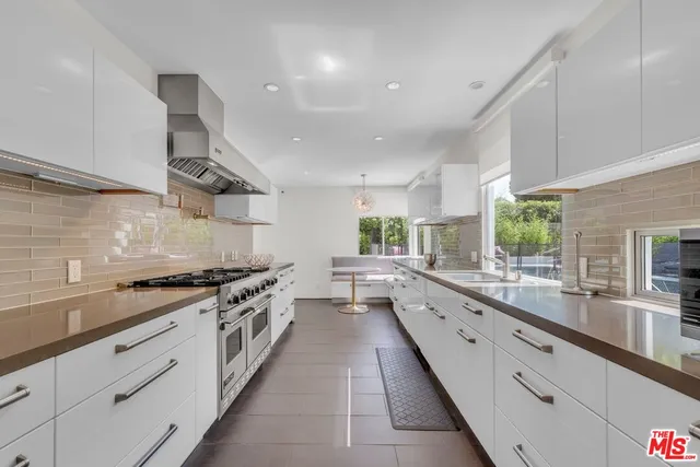 a view of a house with swimming pool and sitting area
