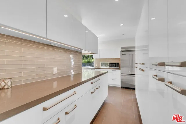 a view of a chairs and table in the backyard
