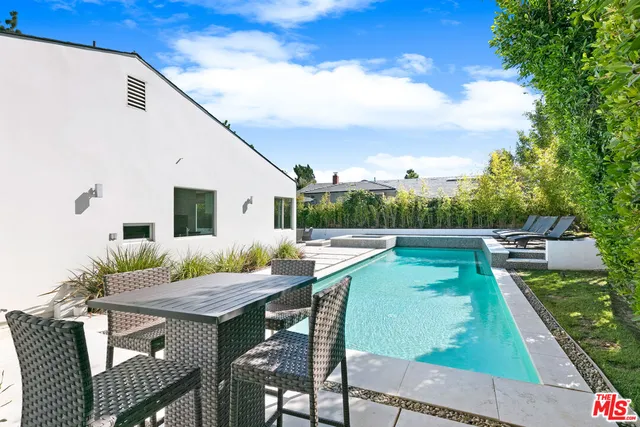 a bathroom with a granite countertop sink mirror and shower