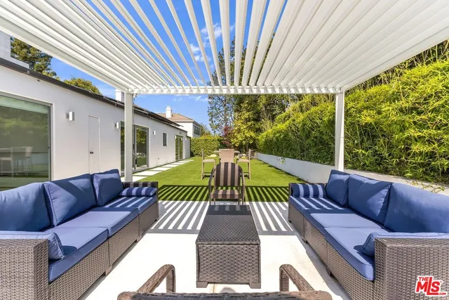 a large kitchen with stainless steel appliances lots of counter space sink and a window